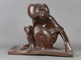 statue of a monkey sitting on top of a wooden base