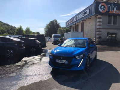 a blue car that is parked in front of a building