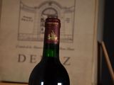 a bottle of wine sitting on a table next to a box