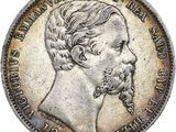 une pièce d'argent représentant le visage d'un homme barbu