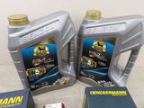 two bottles of motor oil and a book on a table
