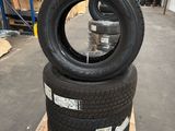 tires stacked on pallets in a warehouse with pallets in the background