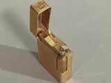 a gold lighter that is sitting on a table