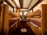 a picture of a train car with two beds in it