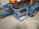 a blue lift truck with a large tire on it