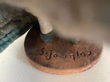 a bronze statue of a bird that is on top of a coin