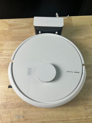 un robot blanc posé sur une table en bois
