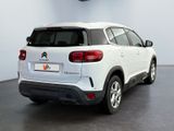 the rear end of a white citrole parked in a showroom