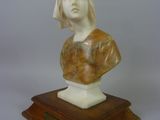 marble bust of a woman on a wooden base on a white background