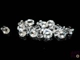 a close up of a bunch of diamonds on a black surface