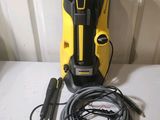 a yellow and black pressurer sitting on top of a table next to a hose