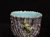 a close up of a small bowl with a frog on it