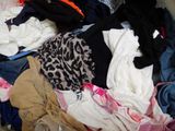 a pile of clothes that is sitting on the floor