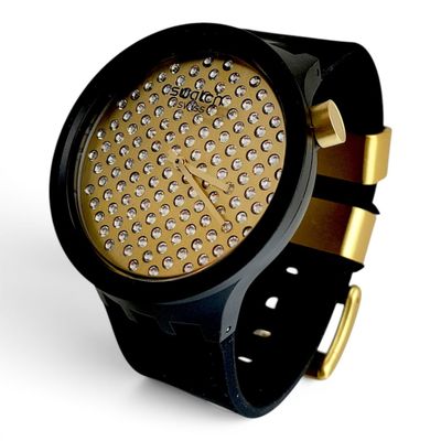 une montre noire et dorée, sertie de nombreux diamants