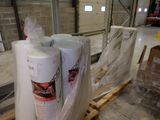 several rolls of toilet paper sitting on top of a pallet in a warehouse
