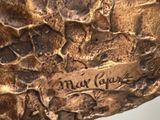 sculpture of a rock with writing on it sitting on a table