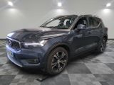 a blue volvo suv parked on a checkered floor in a showroom