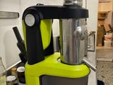 yellow and black blender sitting on top of a counter next to a roll of toilet paper