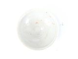 a white bowl with a brown rim on a white surface