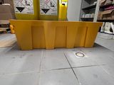 a yellow container sitting on the floor next to a yellow container