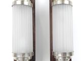 a pair of wall sconces in the style of person