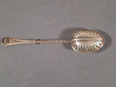 silver plated spoon with a measuring scale on it on a gray surface