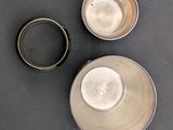 three bowls on the table and one is empty