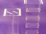 two clear acrylic stands on a purple background with a purple background