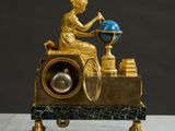 a statue of a woman sitting on top of a clock