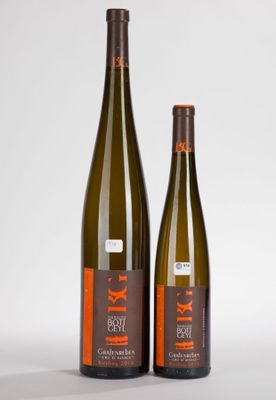 two bottles of wine sitting next to each other on a table