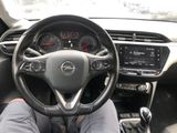 someone is sitting in the driver ' s seat of a car with their feet on the steering wheel