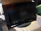 a flat screen tv sitting on a couch in a living room
