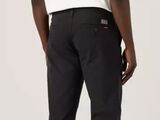 the man is wearing a white t - shirt and black pants