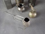 a lot of silver items that are on a table