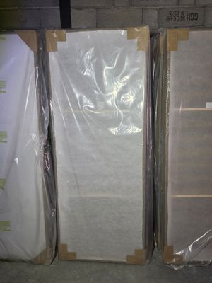 many boxes of mattresses sitting on the floor next to each other