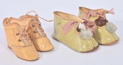 une paire de chaussures de bébé jaunes ornées de pompons