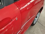 a red car that is parked on the side of the road
