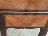 a small wooden table with a drawer on top of it