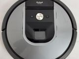 a close up of a robotic vacuum cleaner on a white surface