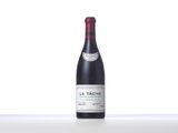 a bottle of red wine sitting on top of a white table