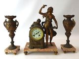 three statues of a woman with a clock and vases