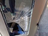 a broken glass window on the front of a car