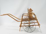 a teddy bear that is sitting in a wooden cart