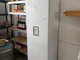 a white refrigerator in a room with shelves and shelves