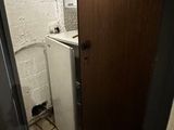 a refrigerator and a sink in a small room