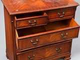 a wooden chest of drawers with two drawers on each side