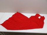 red dress laying on a white table next to a white wall