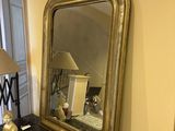 a mirror and a lamp on a dresser in a room
