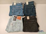 four pairs of levi ' s jeans are stacked on top of each other