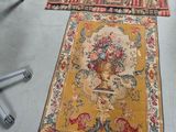 two rugs on the floor in a room with a chair and a desk